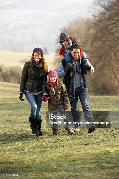 Family On Country Walk In Winter Stock Photo - Download Image Now - 30-39 Years, 4-5 Years, 6-7 Years