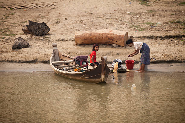 Myanmar travel attraction landmark -  three traditional Burmese fishermen fishing on boats atInle lake in Myanmar famous for their distinctive one legged rowing style