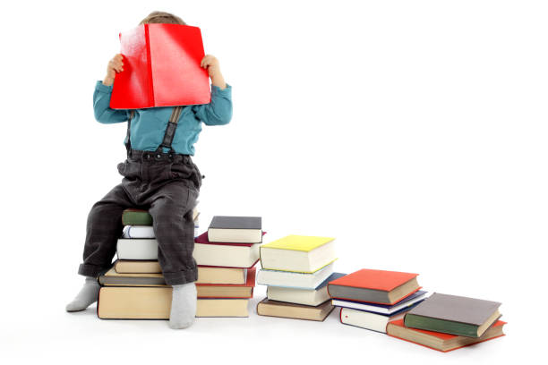 istock Cute baby Boy hiding behind a Big Red Book. 157729014