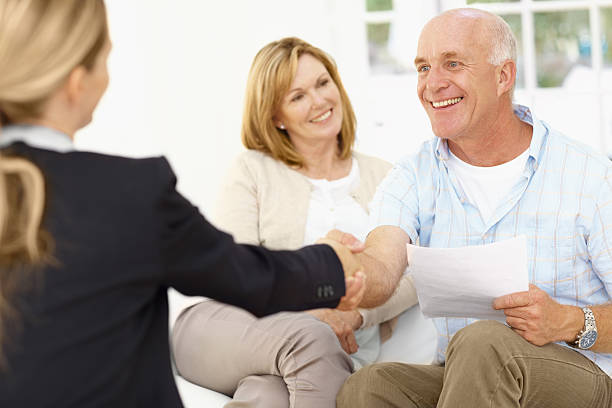 istock Couple being congratulated after signing paperwork 157729090