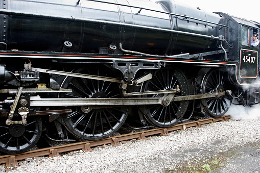 Detail of red wheels of a vintage steam train locomotive