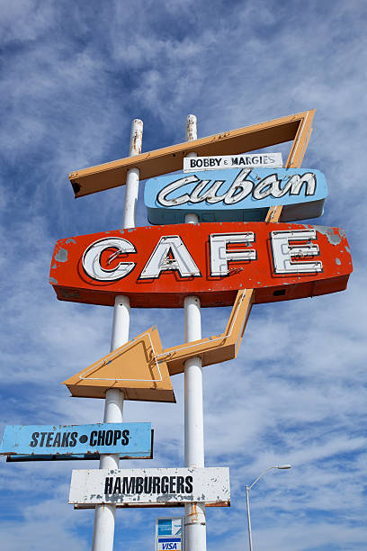 Old vintage gas cafe sign blue sky worn Americana on road roadside