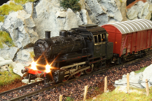 An orange and black railroad diesel locomotive on railroad track.