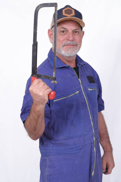 istock white bearded man in blue work clothes holding hammer tool isolated on white background 1577301456