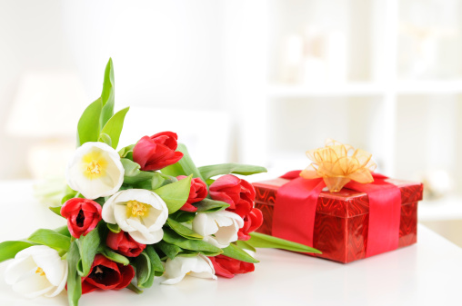 bouquet of red and white tulips, gift box on a table