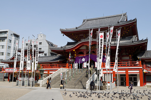 Kyoto, Japan - May 2014: Crowd of people at Heian Shrine main front gate or Oten-mon with decorative large Japanese white lantern and cloudy sky background.