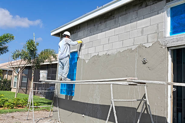 Construction:Real Situation, Stucco contractor Real contractor Putting a base coat of stucco on a house stucco repair stock pictures, royalty-free photos & images
