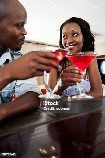 Couple Toasting A Drink At The Bar Stock Photo - Download Image Now - Africa, African Culture, African Ethnicity