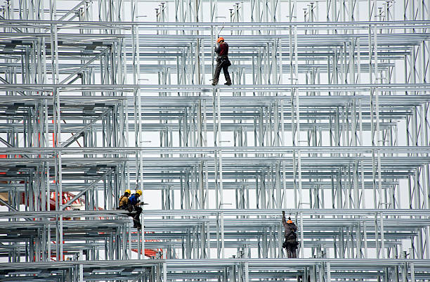 Steel beams and flooring on a building under construction in a city. Fullscreen background.