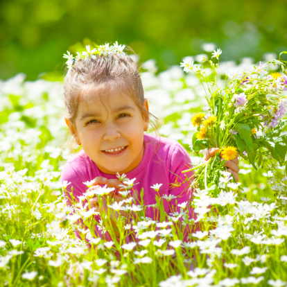 Little girl having fun in the middle of meadow.