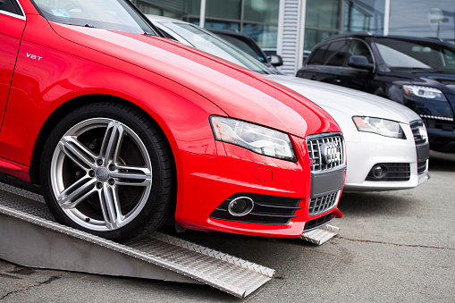 Halifax, Nova Scotia, Canada - March 18, 2012: New Audi vehicles at a car dealership including an Audi S4, an Audi A4 and an Audi Q7.  The high performance S4 sits on top of a raised platform for further exposure on the dealership lot.  The Audi S4 is the high performance version of the popular Audi A4. Beginning production in 1991, the S4 has gone through various versions and each time has increased in performance.
