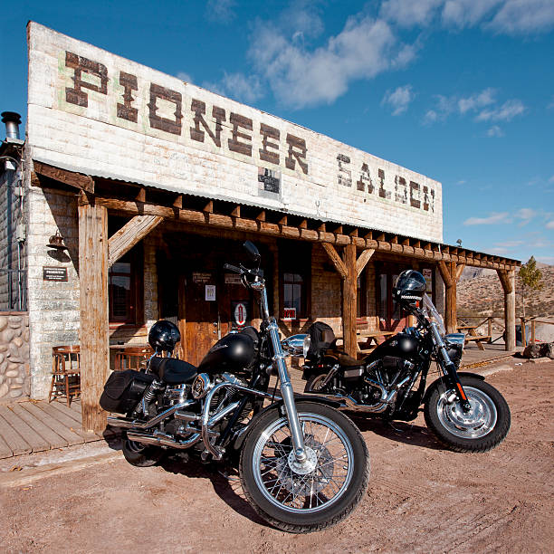 Canyon country, CA- December 8,2005: Motorcycle rider on a Harley Davidson rounds a corner, shot from a moving vehicle.