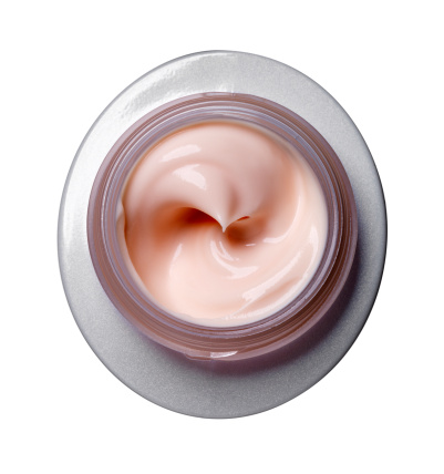 Close-up of open container of cosmetic face cream on white background (with clipping path)   More like this