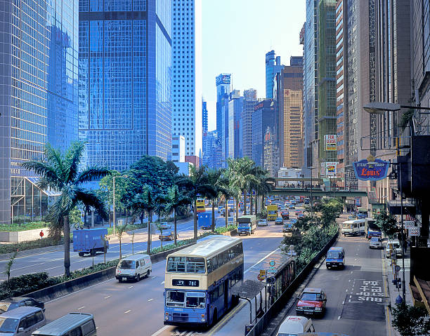 Hong Kong, China - October 10, 2001 : view from a pedestrian bridge on the traffic on Gloucester Road, Wanchai Hong Kong, skyscrapers in the background. Gloucester Road is part of Hong Kong Route 4 and is the only road in Hong Kong with service roads.