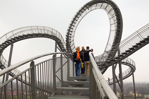 Dolni Morava, Czech Republic, 16 April 2022: Path in the clouds, tourist attraction with spiral platform to observation tower, landscape with forest and sky on mountains, Skywalk with snow