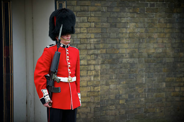 London, UK - June 5 2024: King's Guards march near Buckingham Palace with rifles.