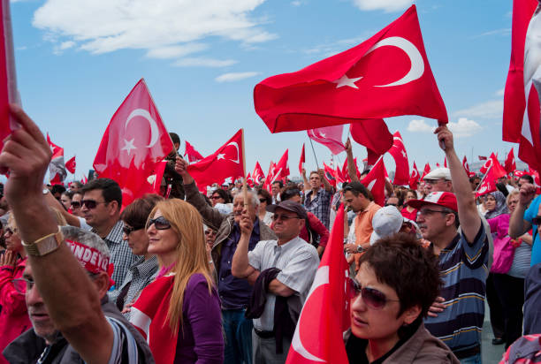 Ankara, Türkiye - February 2, 2008: Crowd visiting Anıtkabir and Turkish flags in hands