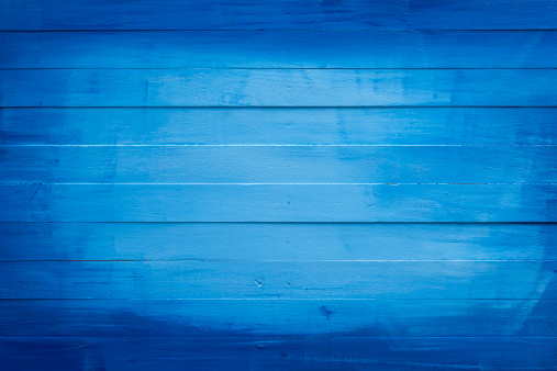 Old blue painted wooden board background. Composite image.