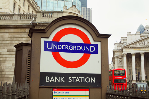 Flag of England with building in the background and bus passing.