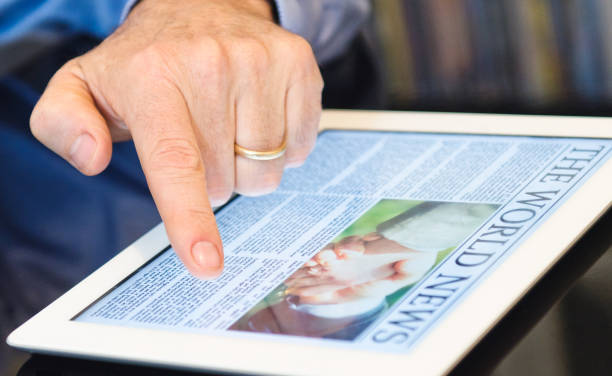 istock Business person reading a newspaper on digital tablet 157732837