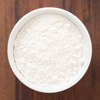 Top view of white bowl full of flour