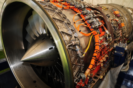 repairing the turbine engine of a passenger jet at a hangar. Open airplane motor