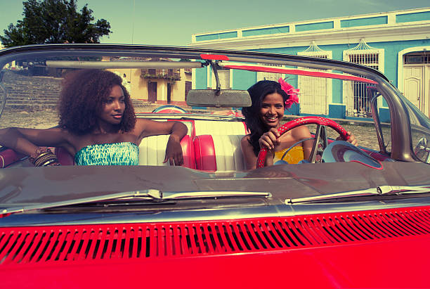 istock Two beautiful cuban woman posing in a red car 157733032