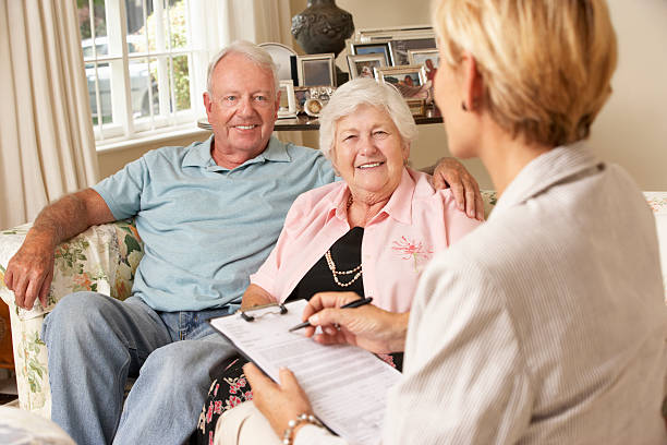 istock Senior Couple Meets with Advisor 157733095