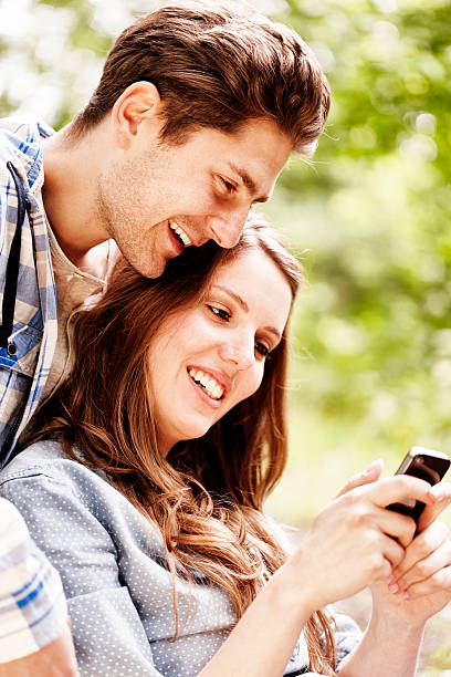 istock Young couple looking at a smart phone 157734115