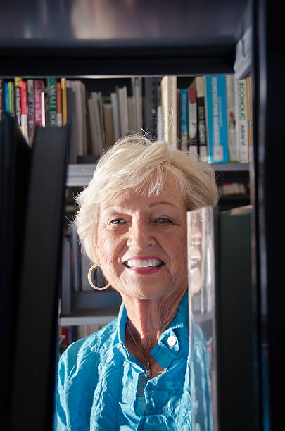 istock Smiling Mature Woman In Library 157734142