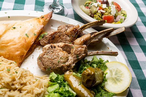 Greek Lamb Chops with Dolmades, Salad and Tiropita in a dinner setting