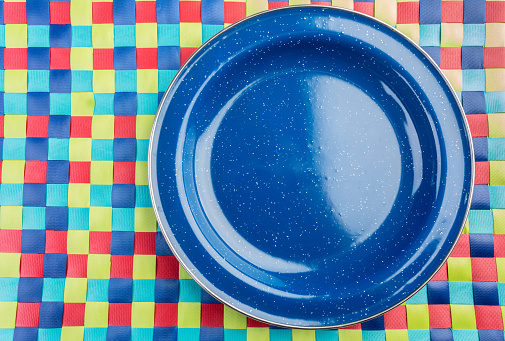 Blue Metal Plate on a colorful place mat in a Casual Dining Picnic Style