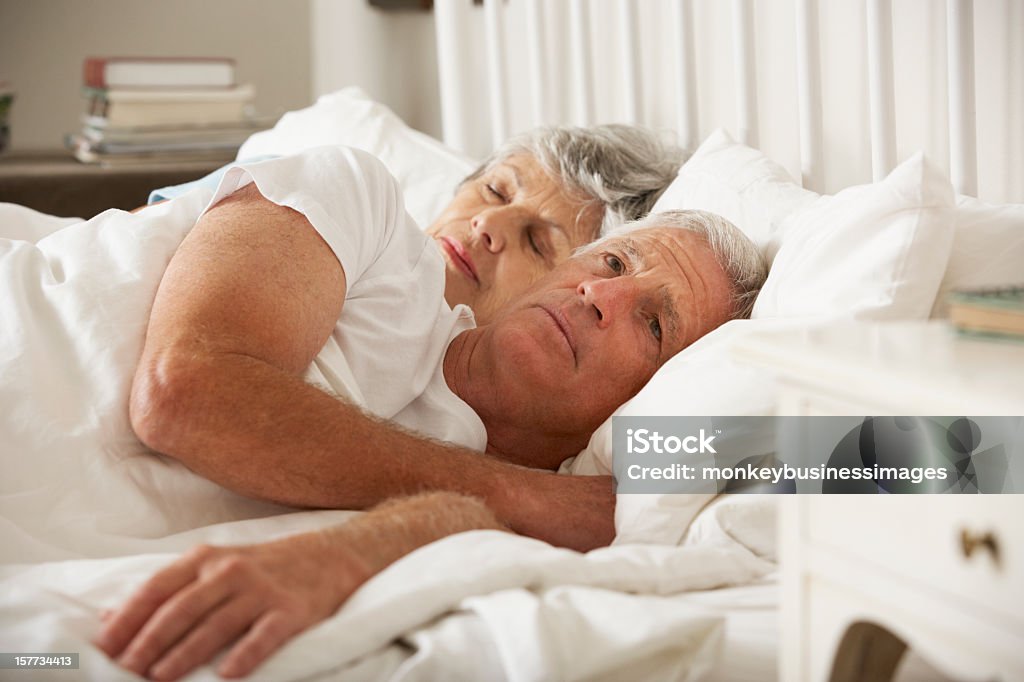 Senior Woman Tries To Be Affectionate Towards Husband In Bed  Sexual Issues Stock Photo