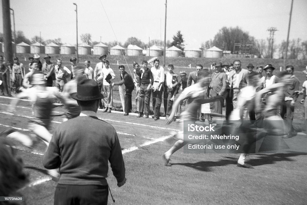 men running in high school track event 1941, retro  Old-fashioned Stock Photo
