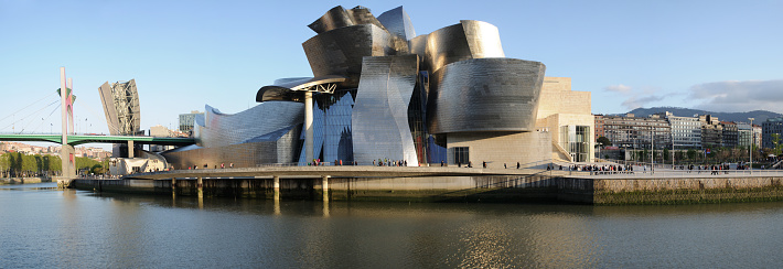 Illusionistic work and exterior view, clad in glass, titanium, and limestone of the famous Guggenheim Museum, a museum of modern and contemporary art designed by Canadian-American architect Frank Gehry, in Bilbao, Basque Country, Spain. It is one of the largest museums in Spain.