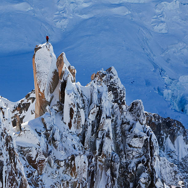 Climber on mountain peak stock photo