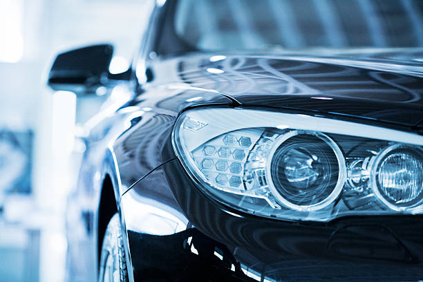 BMW 530d Car Head lights Hamburg, Germany - May 2,  2010 : Close up from the left front of a parking blue BMW 530d. Shallow depth of field with fokus on the headlight. BMW is a German automobile, motorcycle and engine manufacturing company founded in 1916 headlamp stock pictures, royalty-free photos & images