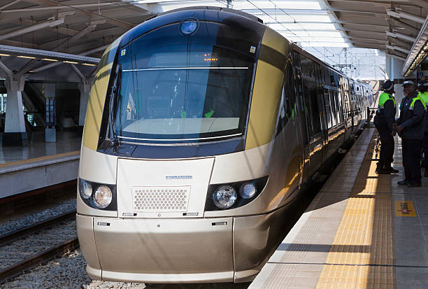 Johannesburg, South Africa - July, 7th 2012: Gautrain Metro arriving at Rothesfield station, Johannesburg with security personnel keeping people behind the yellow line on the platform.