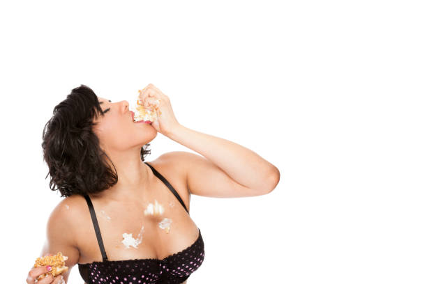 istock Young woman eating birthday cake 157735414