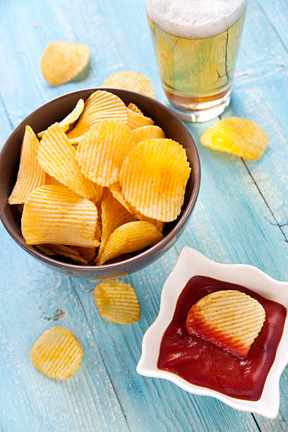 istock Potato chips with ketchup and a beer 157735443