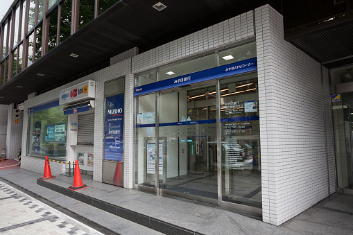 The frontage of a branch of the Nationwide Building Society. Two automated teller machines (ATMs) are available for use.
