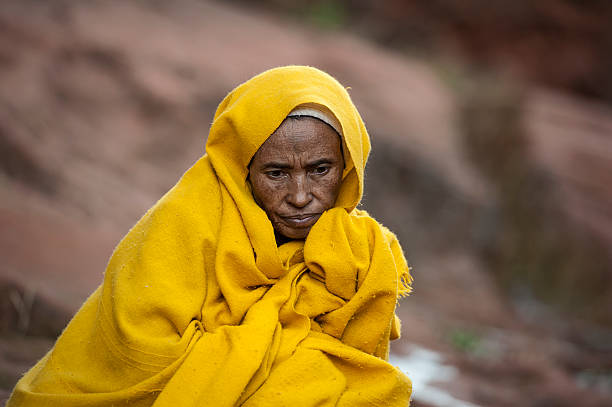 Orthodox pilgrim outside of a rock hewn church, Lalibela, Ethiopia  ethiopian orthodox church stock pictures, royalty-free photos & images