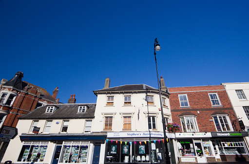 BEVERLEY, UK - 28 MARCH, 2020: Town centre showing prominent retail stores and public house and no people during pandemic lockdown on March 28, 2020 in Beverley, Yorkshire, UK.