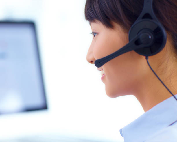 istock pretty young customer service at call center 157735840