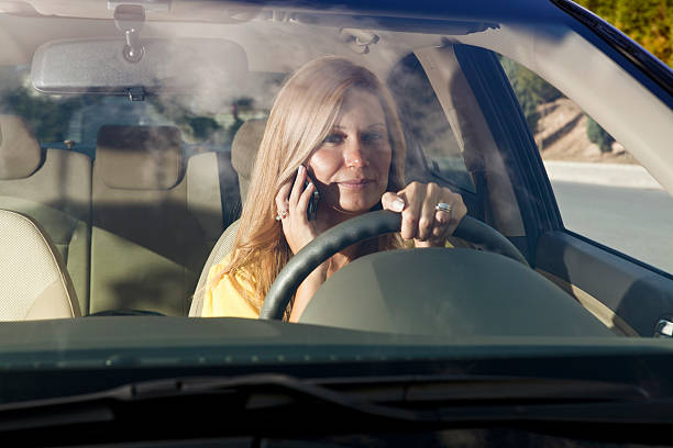 istock female driver on a mobile phone 157735915