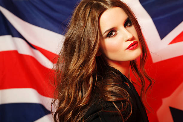 Portrait of a young brunette woman against UK flag stock photo