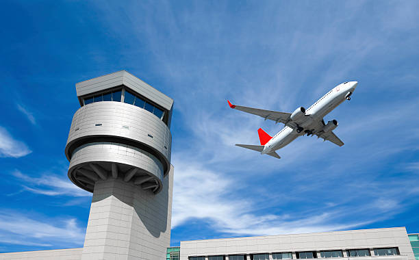 Airport control tower, passenger airplane Airplane and Control Tower. Plane flying past control tower air traffic control tower stock pictures, royalty-free photos & images