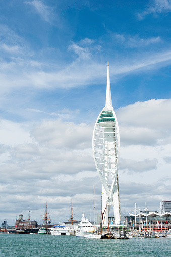Portsmouth, England - August 28, 2011: Spinnaker Tower and Gunwharf Quays in Portsmouth Harbour. Busy shopping centre, ferry and boats can be seen in this picture.