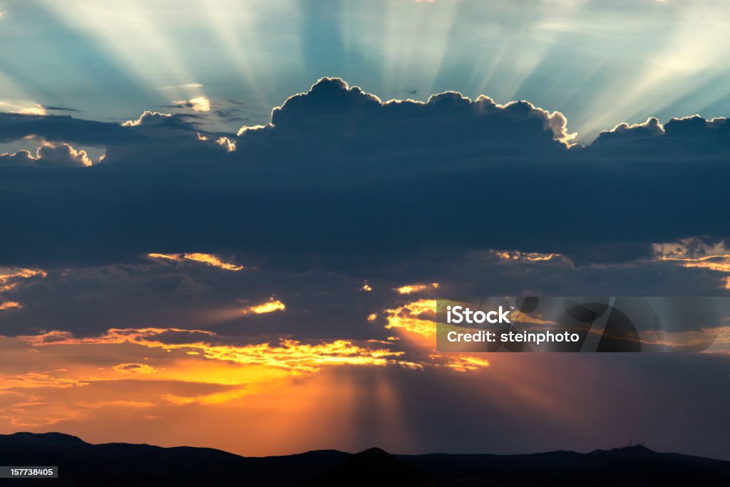 Strahlende Sonne hinter Wolken und Sonnenstrahlen - Lizenzfrei Blau Stock-Foto