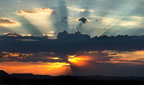 istock Glowing Sun and Sunbeams Behind Clouds 157738594